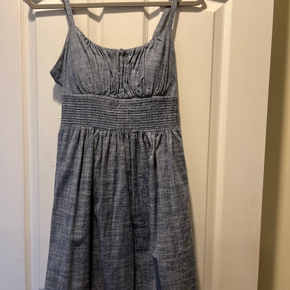 Dress barn size 14 but fits more like a 10. Denim short dress with padded cups.